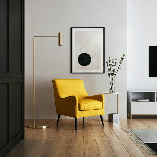 Modern residential living room featuring a yellow armchair, floor lamp, framed artwork, and clean indoor environment, representing healthy indoor air quality and residential air solutions.